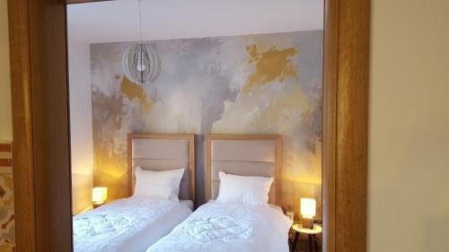 two beds sitting next to each other in a bedroom at Lumer in Kolašin