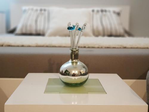 a vase with flowers in it sitting on a table at ARIA OCEAN ACQUA NUEVO VALLARTA in Nuevo Vallarta