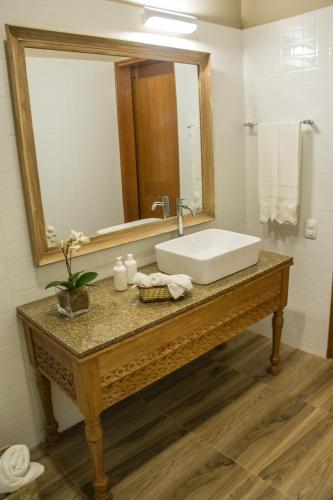a bathroom with a sink and a mirror at Monteverde Boutique Hotel in Pacasmayo