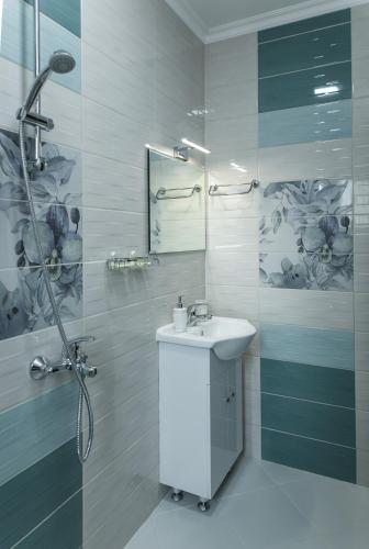 a white bathroom with a sink and a shower at Emmar Zlatograd in Zlatograd