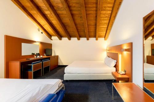 a hotel room with two beds and a sink at Eurostars Residenza Cannaregio in Venice