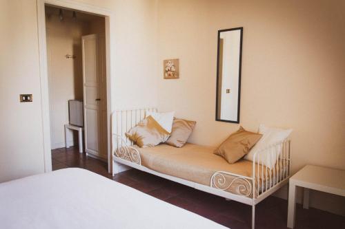 a couch with pillows on it in a room at Antica Dimora Caruso in Catania