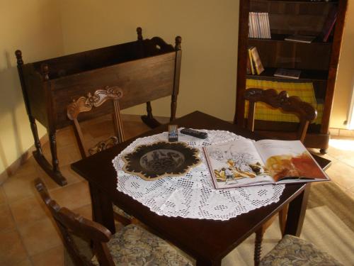 a dining room table with a book and a table at Agriturismo Monbertola in Govone