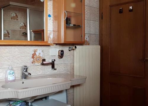 a bathroom with a sink and a mirror at Sunshine Apartment in Köflach