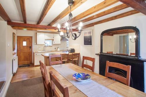 a kitchen and dining room with a table and a fireplace at Host & Stay - Greengate Cottage in York