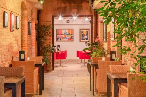 a room with tables and chairs in a building at Eurostars Residenza Cannaregio in Venice