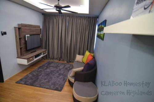 Rumah Tamu By Klaboo في تاناه راتا: غرفة معيشة مع أريكة وتلفزيون