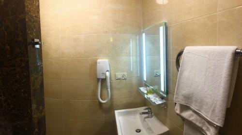 a bathroom with a shower and a sink and a mirror at Non-stop hotel in Boryspilʼ