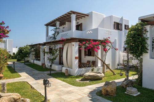 a white house with flowers on the side of it at Anemonisia Skyrian Living in Skiros