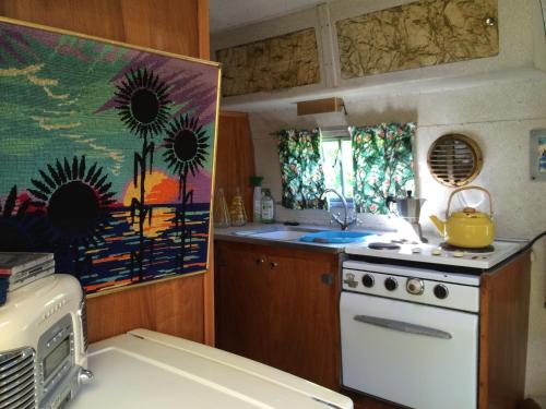 a kitchen with a stove and a yellow pot on the stove at Belrepayre Airstream Camp in Manses