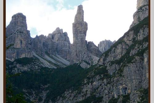 a mountain with tall rocks and trees on it at Ciasa Cimoliana in Cimolais