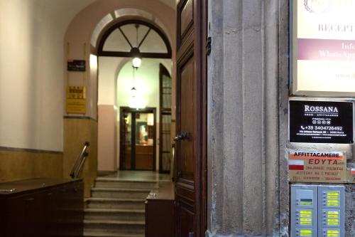 an entrance to a building with a sign on the door at Rossana House in Rome