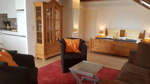 a living room with a bed and a couch at BellaRosa in Emmetten