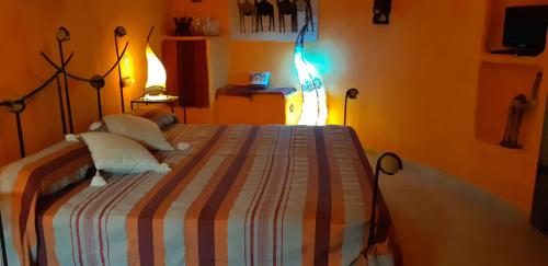 
a bedroom with a bed and a lamp at Hotel Cueva Tardienta Monegros-Adults Only in Tardienta
