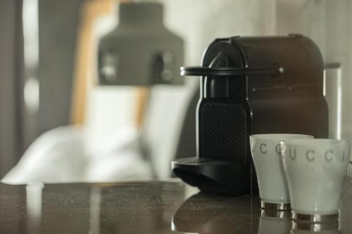 a coffee maker and two cups on a counter at Urban Living 2 in Thessaloniki