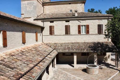 an outside view of a building with a roof at Castello Montegiove in Fano