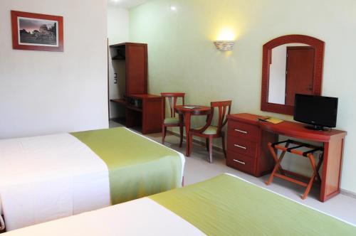 Cama ou camas em um quarto em Hotel Posada Sian Kaan Playa del Carmen