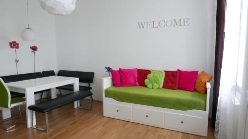 a room with a bed with a desk and a table at govienna - City Center Apartments in Vienna