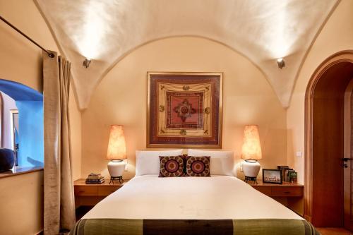 a bedroom with a large white bed with two lamps at Lazib Inn Resort & Spa in Tunis