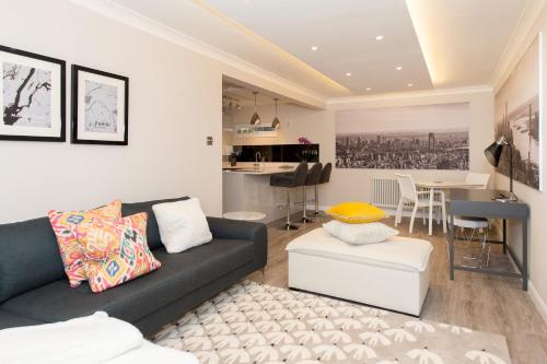 a living room with a couch and a table at The Mews, York Place by Harrogate Serviced Apartments in Harrogate