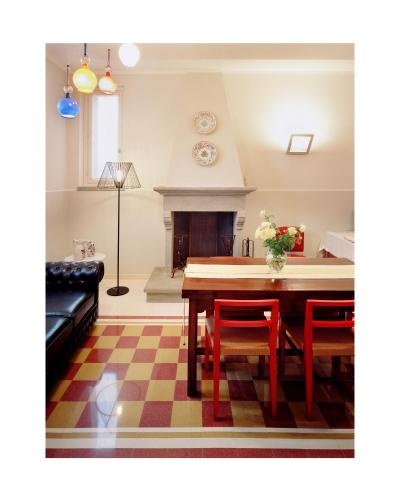 a living room with a table and chairs and a fireplace at Roccafiore Wine Resort & Spa in Todi