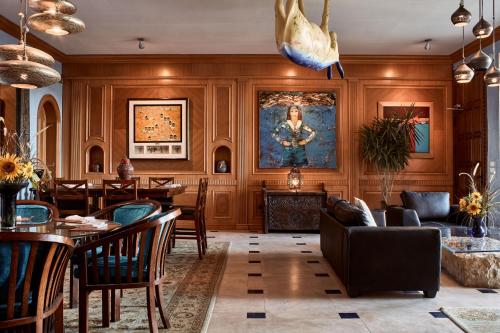 a living room with wood paneling and a dining room at Lazib Inn Resort & Spa in Tunis