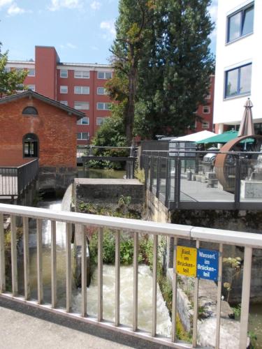 a railing with a sign on it in front of a building at Fewo-Rosenheim im Zentrum mit kostenlosem Parkplatz in Rosenheim