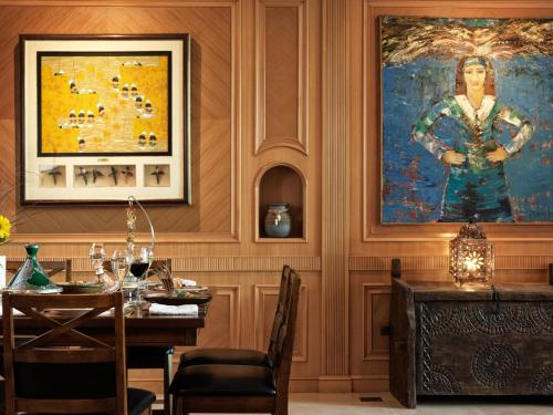 a dining room with a table and a painting on the wall at Lazib Inn Resort & Spa in Tunis