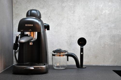 a coffee maker sitting on top of a counter at Ludwinowska11 Apartments in Kraków