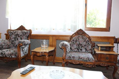 a living room with two chairs and a table at Къща за гости-"Борики"-Габрово in Gabrovo