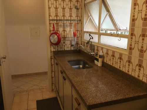 a kitchen with a sink and a window at RelaxRP in Ribeirão Preto
