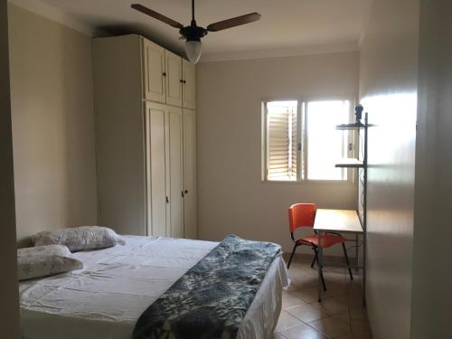 a bedroom with a bed and a ceiling fan at RelaxRP in Ribeirão Preto