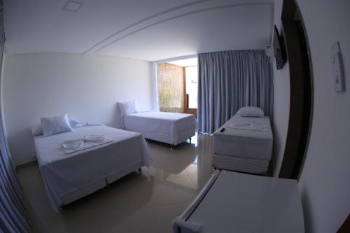 En eller flere senge i et værelse på Gabrielly Praia Hotel