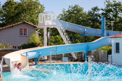 a blue water slide in a swimming pool at MH Camping 4* face Royan in Soulac-sur-Mer