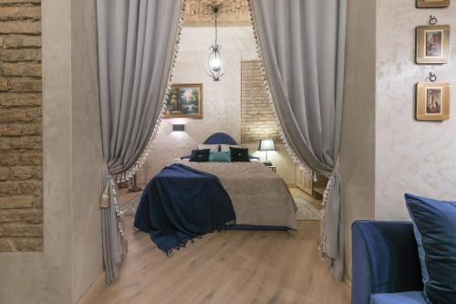 a bedroom with a bed with gray curtains at Luxury apartment in Pilies street in Vilnius