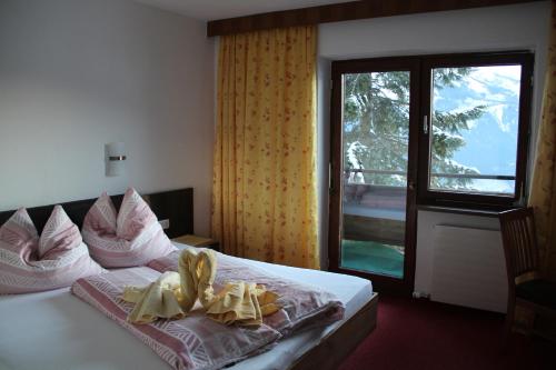 a hotel room with a bed with towels on it at Gastehaus Egger in Mittersill