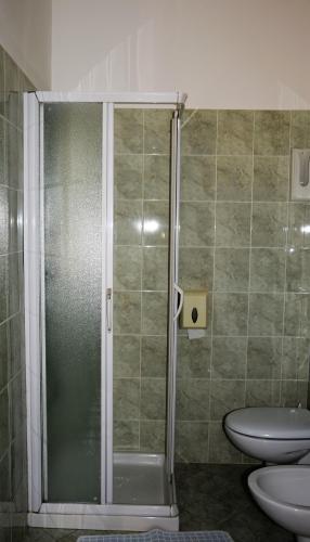 a shower in a bathroom with a toilet and a sink at Hotel Ristorante Da Marco in San Mauro a Mare