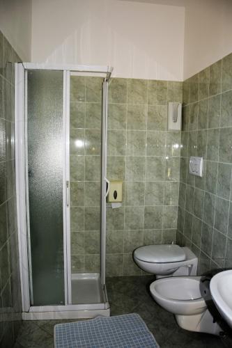 a bathroom with a shower and a toilet and a sink at Hotel Ristorante Da Marco in San Mauro a Mare