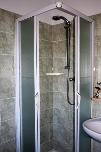 a shower with a glass door in a bathroom at Hotel Ristorante Da Marco in San Mauro a Mare