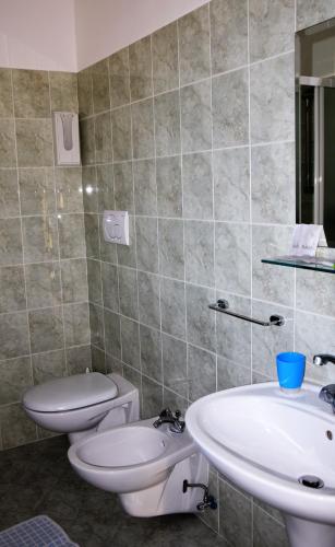 a bathroom with a toilet and a sink at Hotel Ristorante Da Marco in San Mauro a Mare