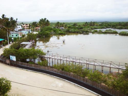 a view of a river with a bridge at Hotel La Laguna Galapagos in Puerto Villamil