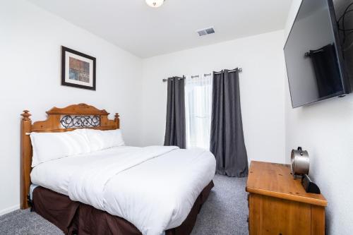 a bedroom with a bed and a television in it at Den Haven Entire Home Near DIA With Three Bedrooms And Private En Suite Baths in Denver