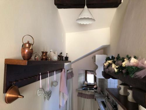 a kitchen with a sink and shelves and towels at La finestra sulla Toscana in Cortona