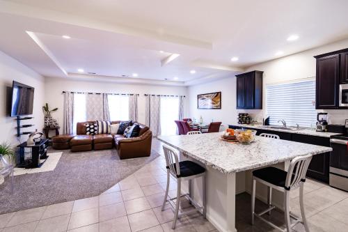 a kitchen and living room with a table and chairs at Den Haven Entire Home Near DIA With Three Bedrooms And Private En Suite Baths in Denver