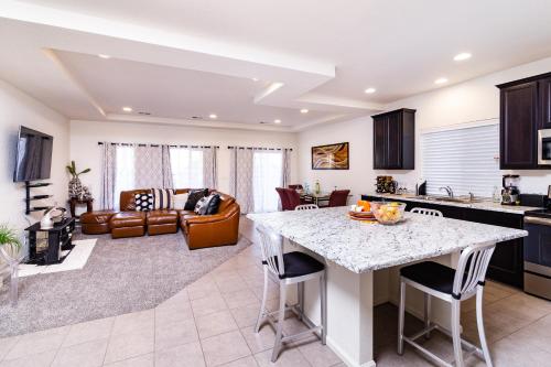a kitchen and living room with a table and chairs at Den Haven Entire Home Near DIA With Three Bedrooms And Private En Suite Baths in Denver