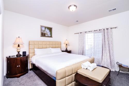 a bedroom with a large white bed and a window at Den Haven Entire Home Near DIA With Three Bedrooms And Private En Suite Baths in Denver