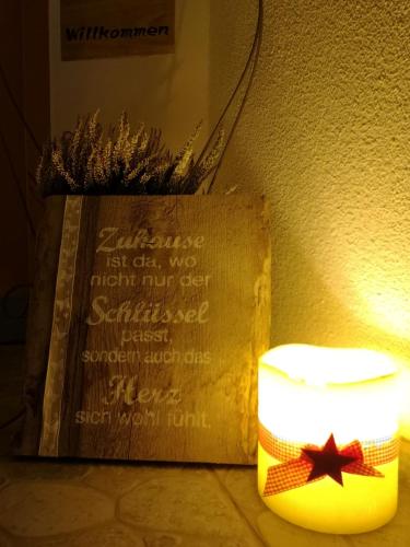 a sign on a wall next to a lamp with a star at Haus Marieus in Umhausen