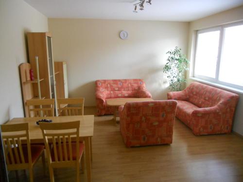 a living room with a couch and chairs and a table at Penzion Kaplna in Kaplna