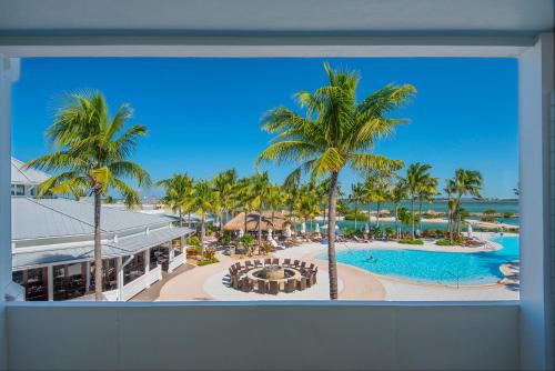 a view of a resort with a pool and palm trees at Hawks Cay Resort in Marathon