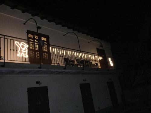 a building with a balcony with lights on it at night at Dely B&B in Arquata Scrivia